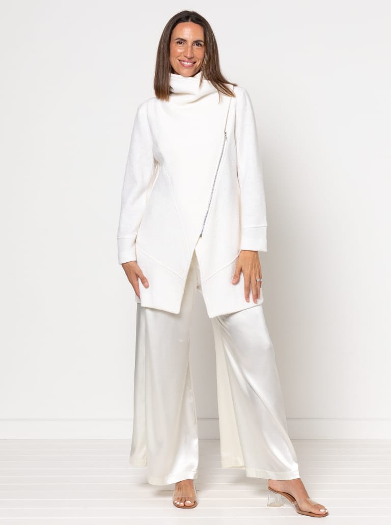 Woman wearing the Genevieve Jacket sewing pattern from Style Arc on The Fold Line. A jacket pattern made in wool cashmere, boiled wool, ponte, or jacket weight linen fabric, featuring a large shawl collar, angled seams and darts, an asymmetrical zip front, two-piece sleeves, and in-seam pockets.