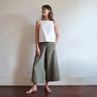Woman wearing the Grazia Culottes sewing pattern from Tessuti Fabrics on The Fold Line. A trousers pattern made in linen or linen blend, cottons, wool or wool blend fabric, featuring a high-rise waist that is flat at the front and elasticated at the back, cropped wide legs, in-seam pockets, topstitched back yokes, forward side seams, and hem facings.