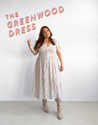 Woman wearing the Greenwood Dress sewing pattern from Les Perlines on The Fold Line. A dress pattern made in rayon, viscose, cotton, linen, or tencel twill fabric, featuring a V-neck, button front, short flutter sleeves, gathered skirt, and midi length.