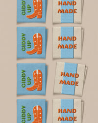 'Hand Made Cowboy Boot Square' woven labels from Matchy Matchy Sewing Club on The Fold Line. The pack includes 8 woven labels to sew onto your handmade clothes and accessories.