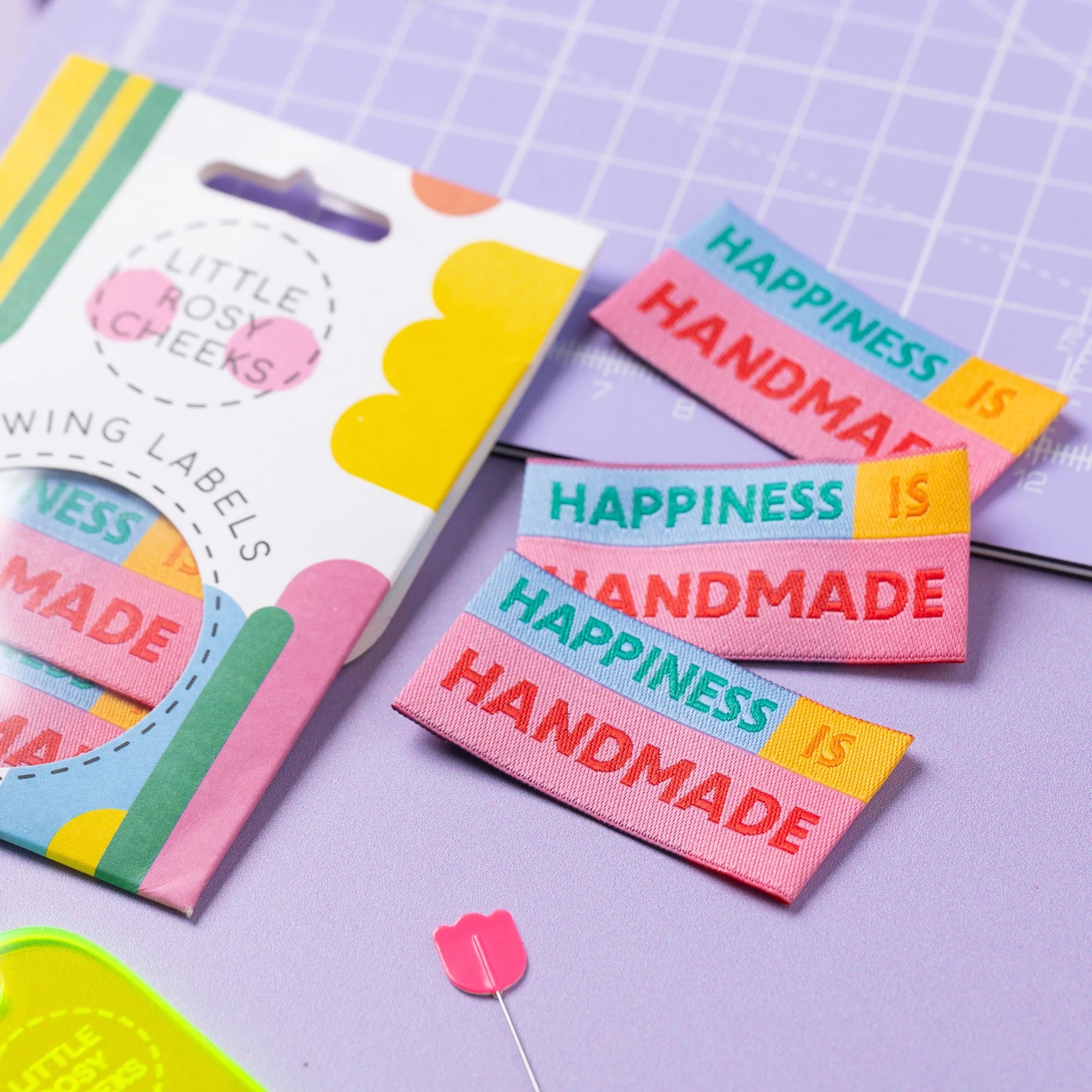 The 'Happiness Is Handmade' woven labels from Little Rosy Cheeks on The Fold Line. The pack includes 6 labels in bright colours ready to be sewn into your handmade clothes.