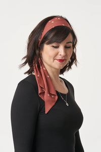 Woman wearing the Headscarf sewing pattern from Sew Over It on The Fold Line. A headscarf pattern made in crepe, viscose, or cotton lawn fabric, featuring long ties and hidden elastic.