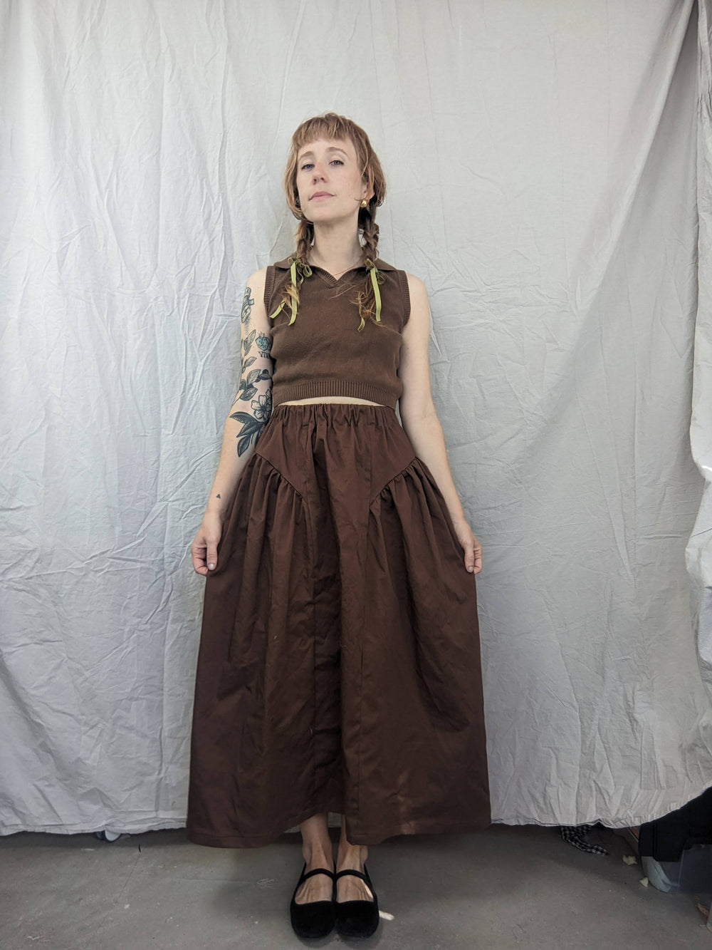 Woman wearing the Henrietta Skirt sewing pattern from Spaghetti Western Sewing on The Fold Line. A skirt pattern made in cotton poplin, voile, lawn, batiste, linen, rayon, lyocell, tencel, or washed cotton fabric, featuring an elastic waist and gathered side panels.