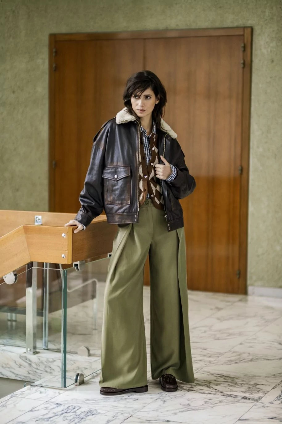 Woman wearing the Ivanna Trousers sewing pattern from Fibre Mood on The Fold Line. A trousers pattern made in gabardine, denim, corduroy, or linen fabric, featuring a shaped waistband, fly front, pleats at the front and back, and wide leg.