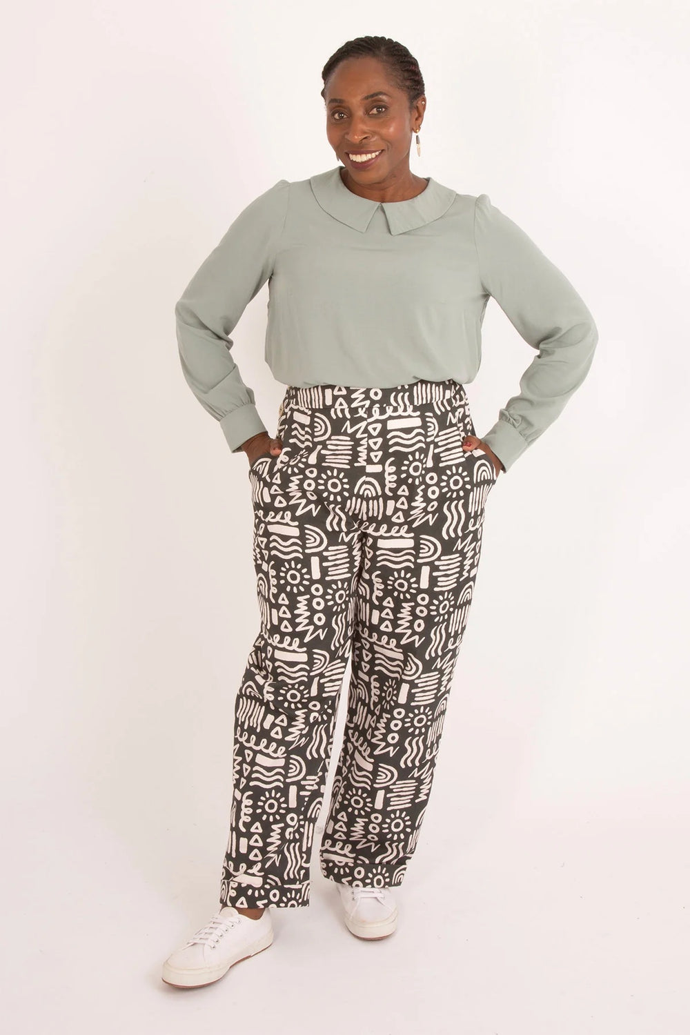 Woman wearing the Jacinta Blouse sewing pattern from Sew Over It on The Fold Line. A top pattern made in viscose, crepe, silk, georgette, or cotton lawn fabric, featuring a round neckline, flat collar, long puff sleeves with cuffs, and a keyhole opening at the back.
