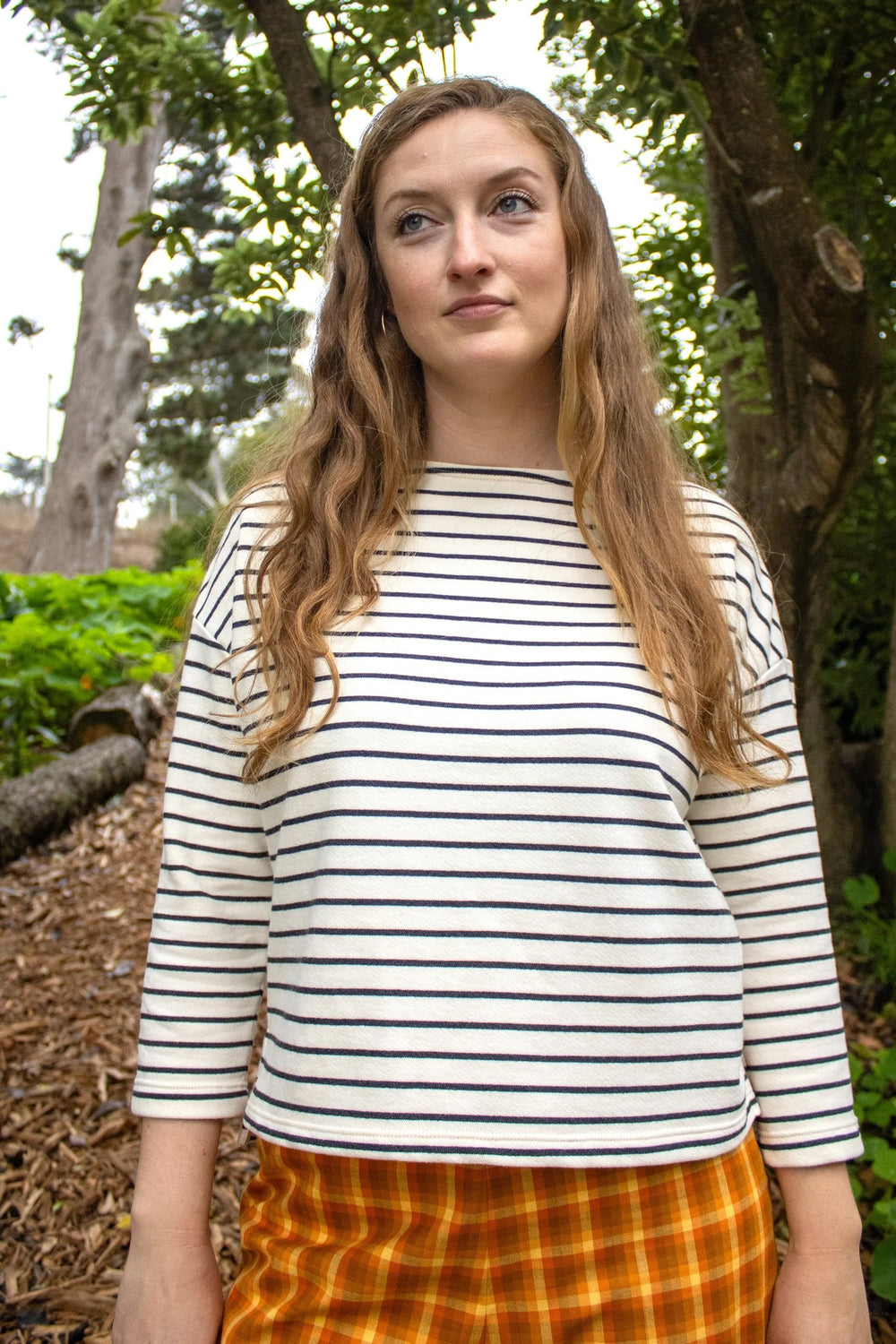 Woman wearing the James Tee sewing pattern from Christine Haynes on The Fold Line. A top pattern made in French terry, ponte, interlock knit, double knit, or jersey knit fabric, featuring a boxy fit, boatneck, drop shoulders, and bracelet length sleeves.