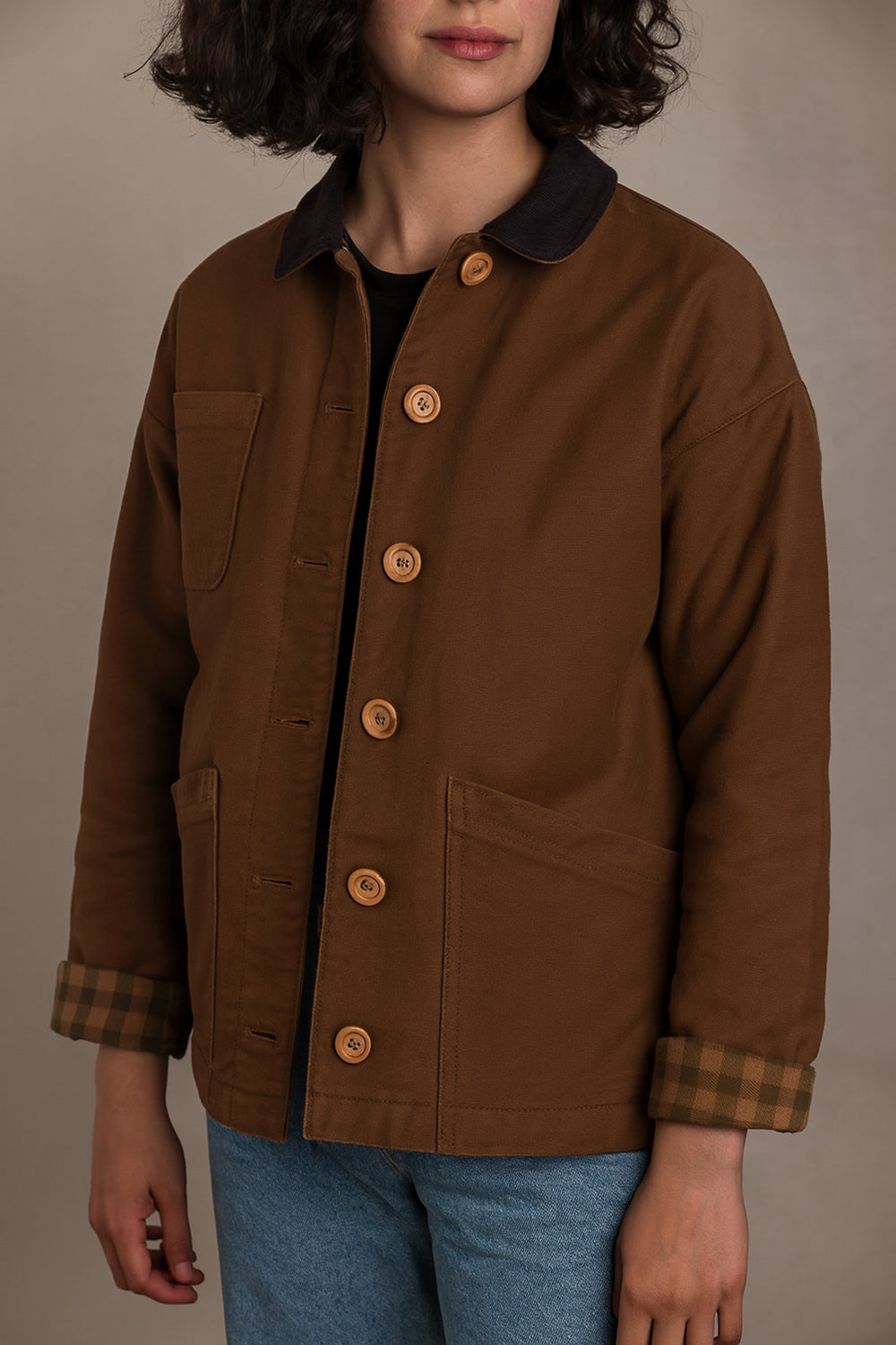 Woman wearing the Julien Chore Jacket sewing pattern from Ready to Sew on The Fold Line. A jacket pattern made in moleskin, denim, cotton twill, corduroy, or faux fur fabric, featuring a boxy fit, full lining, collar, button closure, and patch pockets.