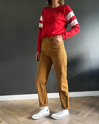 Woman wearing the Jupiter Jeans sewing pattern from French Navy on The Fold Line. A jeans pattern made in denim fabric, featuring a curved waistband, fly front, five pocket styling, and tapered leg with a twisted side seam.