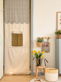 The Kiosk sewing pattern from Me & Kiddo Patterns on The Fold Line. A doorway curtain that becomes a pretend serving hatch or theatre made in cotton, cotton canvas, or linen fabric, featuring an opening with a roll-up flap.
