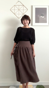 Woman wearing the La Ciotat Wrap Skirt sewing pattern from Sewing Therapy on The Fold Line. A skirt pattern made in linen, cotton lawn, voile, poplin, double gauze, rayon, viscose, tencel, seersucker, or light chambray fabric, featuring gathering and double ties.