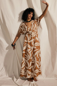 Woman wearing the La Robe Butterfly sewing pattern from Atelier Brunette on The Fold Line. A caftan dress pattern made in viscose, cotton, or modal fabric, featuring a deep V wrap neckline, short grown-on sleeves, elastic and drawstring waist, side slits, and maxi length.