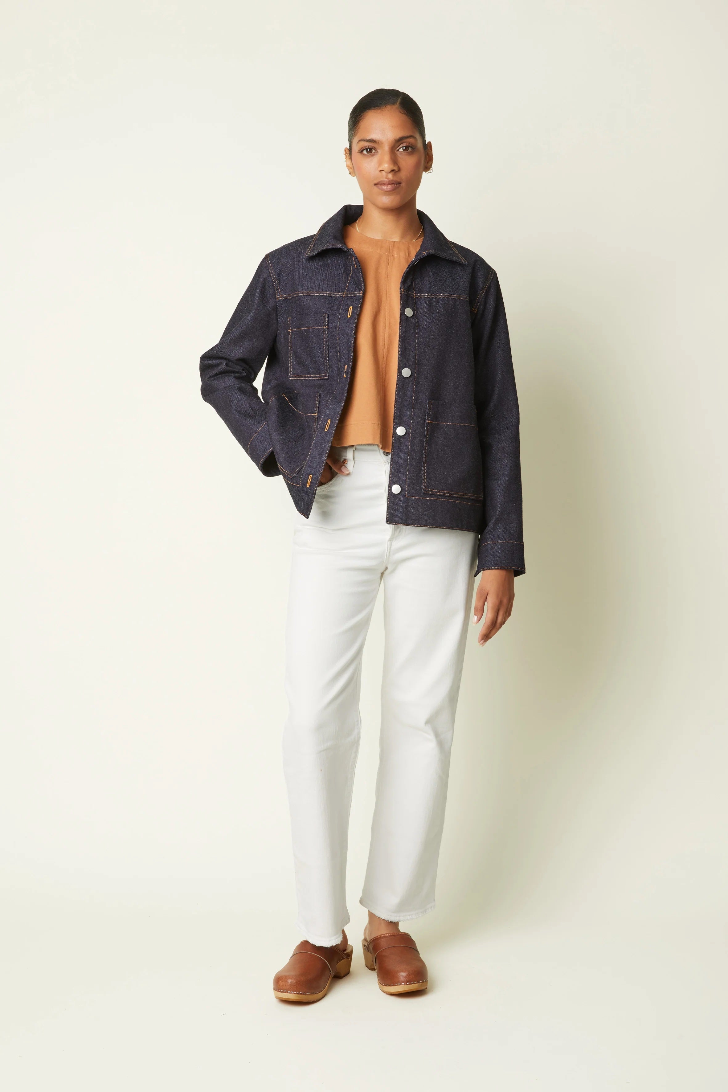 Woman wearing the La Veste sewing pattern from Atelier Brunette on The Fold Line. A workwear jacket pattern made in corduroy, gabardine, or jacquard fabric, featuring a collar, lined yoke, button front, and patch pockets.