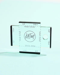 The Label Gauge from Kylie & The Machine on The Fold Line. This tea green acrylic gauge with laser-etched measurements will help you to position your label perfectly.