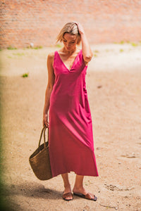 Woman wearing the Laleh Dress sewing pattern from Fibre Mood on The Fold Line. A sleeveless dress pattern made in viscose, silk, lyocell, crepe, chambray, double gauze, seersucker, lightweight twill, poplin, or linen fabric, featuring a deep V-neckline at the front and back, bust darts, invisible zip in the side seam, back slit, and midi length.