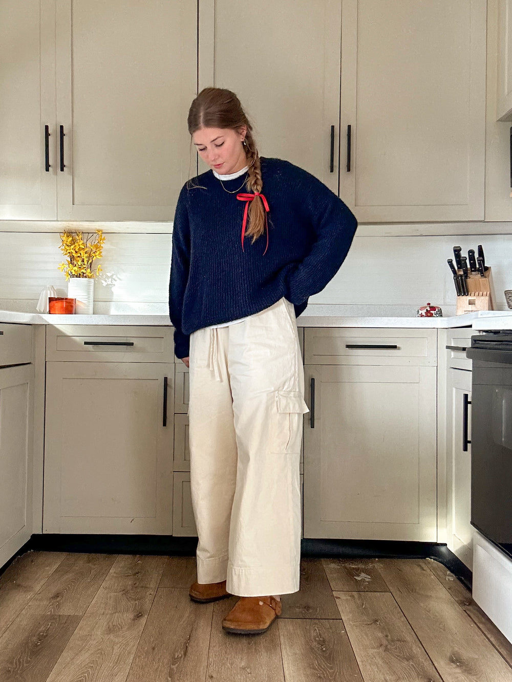 Woman wearing the Lane Pants sewing pattern from Syd Graham Patterns on The Fold Line. A trousers pattern made in cotton or linen fabric, featuring a relaxed fit, high waist, drawstring, wide leg, and cargo pockets.