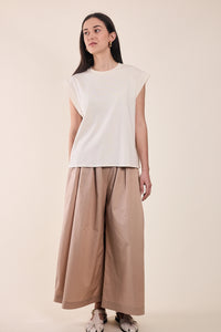 Woman wearing the Le T-Shirt sewing pattern from Atelier Brunette on The Fold Line. A sleeveless top pattern made in modal jersey or cotton jersey fabric, featuring a relaxed fit, round neckline, and wide armholes.