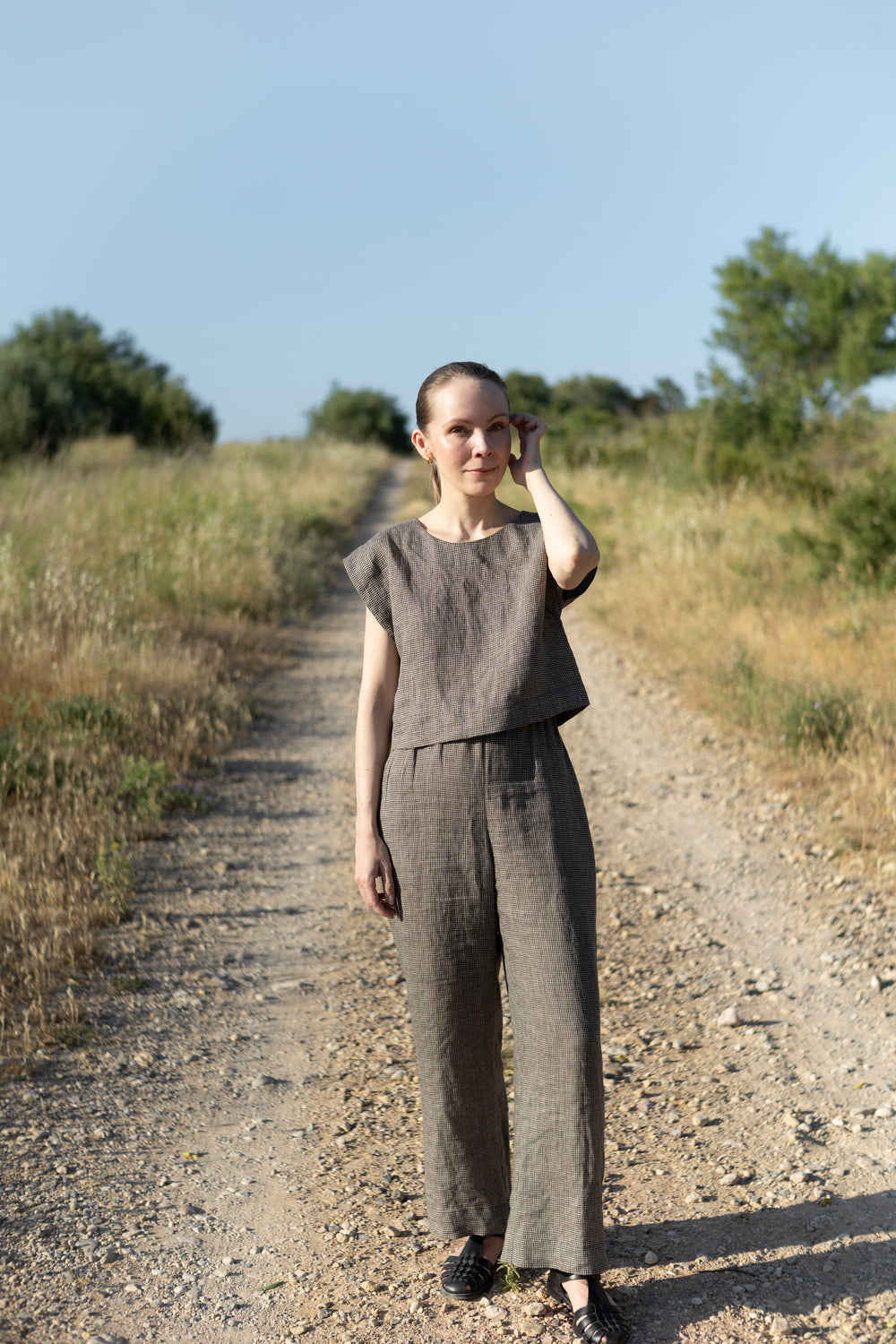 Woman wearing the Lea Top and Pants sewing pattern from Silversaga Patterns on The Fold Line. A top and trousers pattern made in linen, hemp, soft cottons, cotton block prints, linen blends, tencel twill, or rayon/viscose fabric, featuring a top with a round neckline and grown-on short sleeves, and trousers with a high elasticated waist and in-seam pockets.