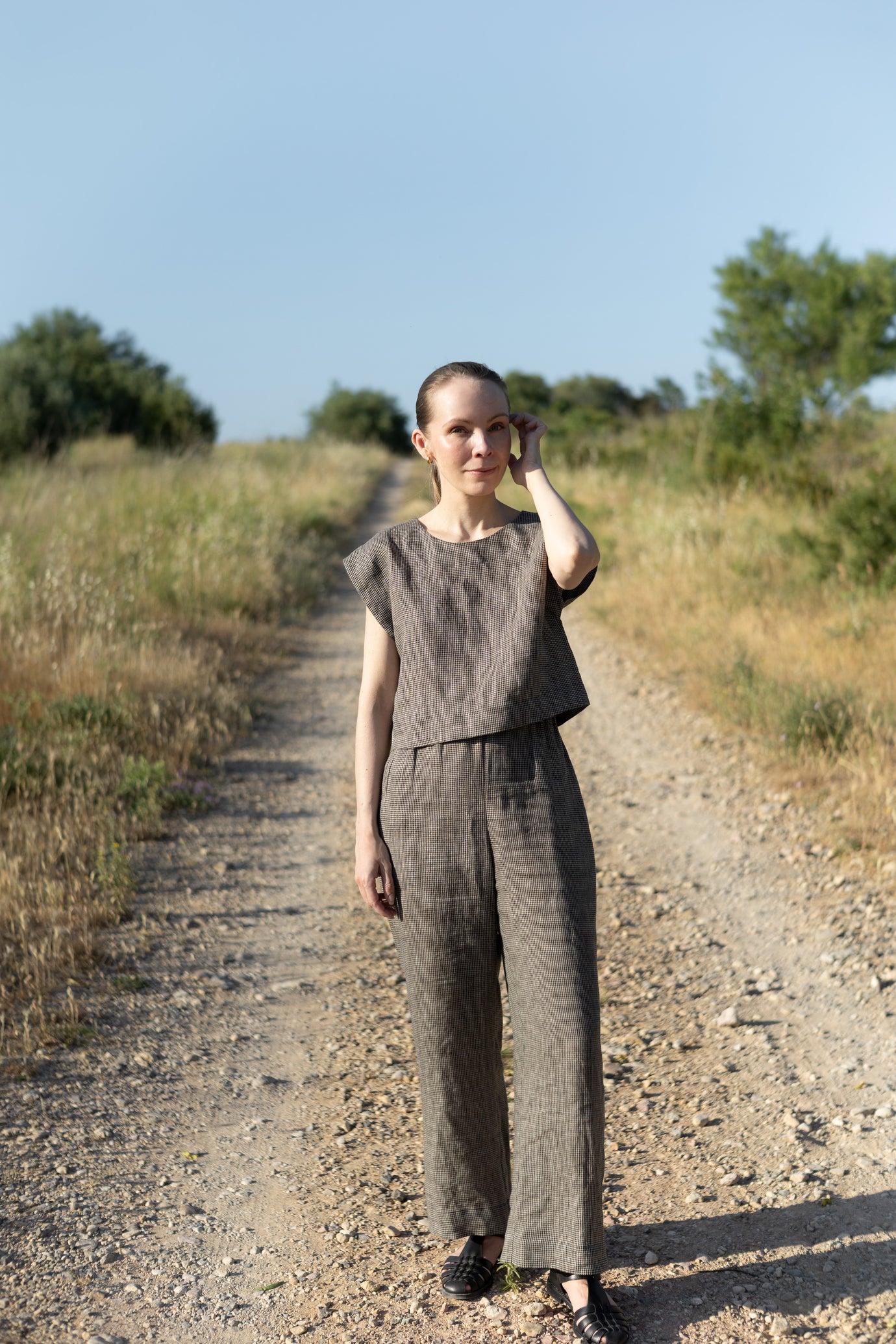 Woman wearing the Lea Top and Pants sewing pattern from Silversaga Patterns on The Fold Line. A top and trousers pattern made in linen, hemp, soft cottons, cotton block prints, linen blends, tencel twill, or rayon/viscose fabric, featuring a top with a round neckline and grown-on short sleeves, and trousers with a high elasticated waist and in-seam pockets.