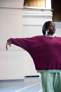 Woman wearing the Lumi Jumper sewing pattern from TAUKO on The Fold Line. A sweatshirt pattern made in knit, jersey, plush, linen, double gauze, silk, or tencel fabric, featuring an oversized fit, round neck, batwing sleeves, and  front pockets.