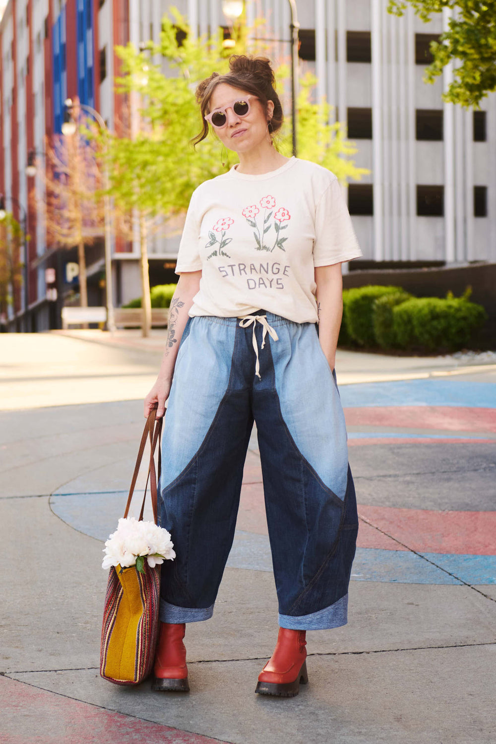 Woman wearing the Madrone Pants sewing pattern from Sew Liberated on The Fold Line. A trousers pattern made in sandwashed linen or cotton, light canvas, light twill, or cotton-linen blend fabric, featuring a relaxed fit, elastic and drawstring waist, curved seams with topstitching, pockets, and barrel leg.