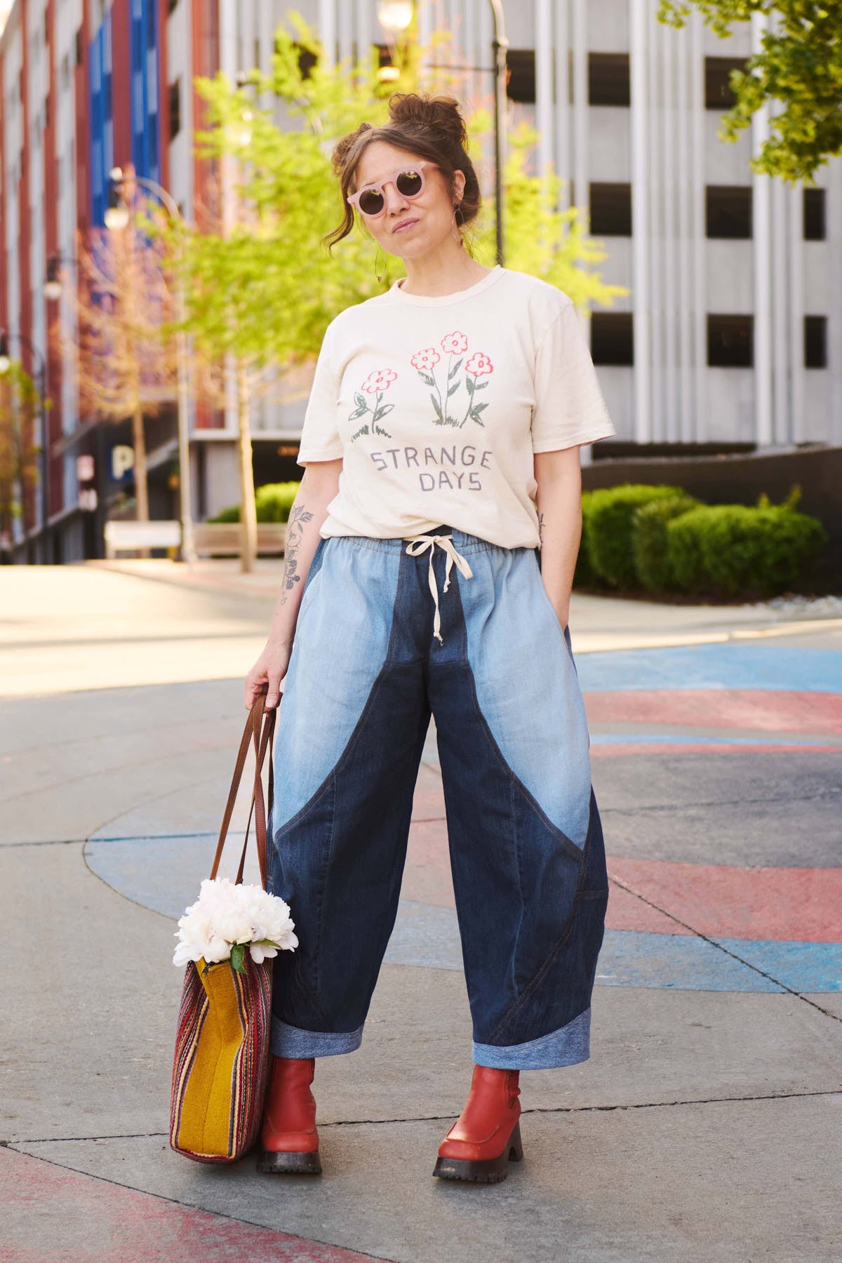 Woman wearing the Madrone Pants sewing pattern from Sew Liberated on The Fold Line. A trousers pattern made in sandwashed linen or cotton, light canvas, light twill, or cotton-linen blend fabric, featuring a relaxed fit, elastic and drawstring waist, curved seams with topstitching, pockets, and barrel leg.