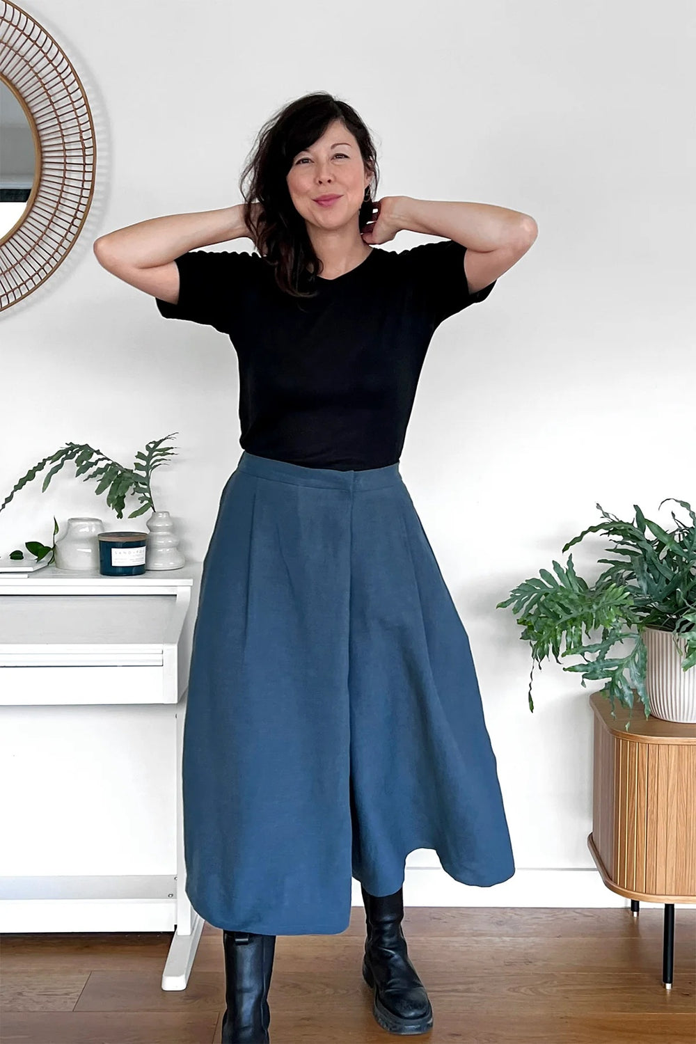 Woman wearing the Malvern Culottes sewing pattern from In the Folds on The Fold Line. A culottes pattern made in linen, linen blend, cotton twill, cotton poplin, mid weight denim, lightweight wool, sateen, silk, or viscose (rayon) fabric, featuring a wrap front, pleats, side seam pockets, and mid-calf length.