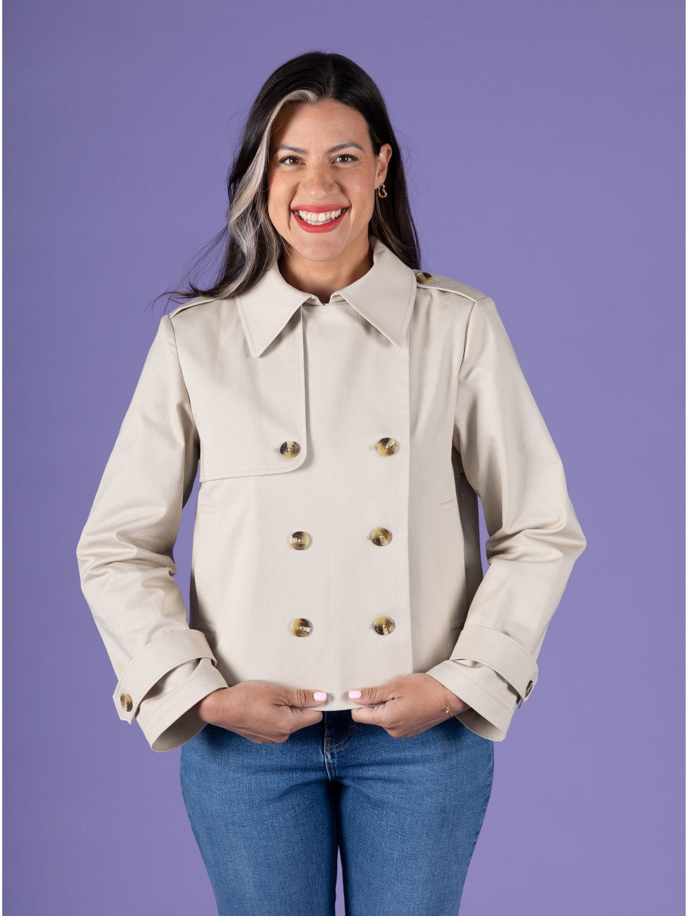 Woman wearing the Manon Jacket sewing pattern from Tilly and the Buttons on The Fold Line. An unlined jacket pattern made in cotton twill, gabardine, or wool fabric, featuring a convertible collar, double-breasted button front, storm flap and shield, epaulettes, sleeve straps, welt pockets, and cropped length.