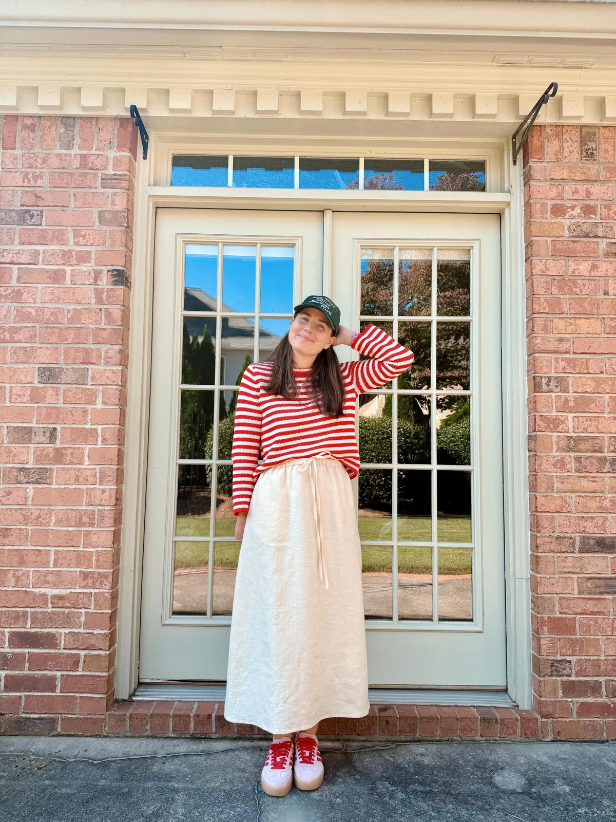 Woman wearing the Margot Skirt sewing pattern from Me & Kiddo Patterns on The Fold Line. A skirt pattern made in cotton or linen fabric, featuring an elastic waist with a tie, pockets, and midi length.