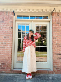 Woman wearing the Margot Skirt sewing pattern from Me & Kiddo Patterns on The Fold Line. A skirt pattern made in cotton or linen fabric, featuring an elastic waist with a tie, pockets, and midi length.