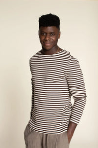 Man wearing the Men’s Breton T-shirt sewing pattern from Wardrobe by Me on The Fold Line. A T-shirt pattern made in jersey fabric, featuring a straight cut, boat neckline, and long set-in sleeves.