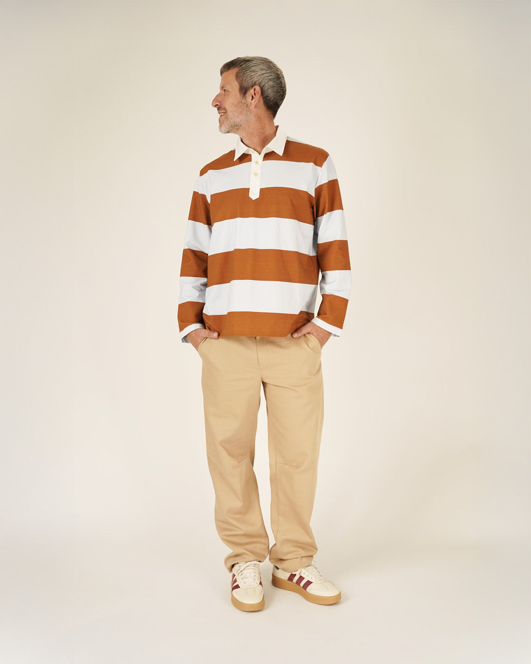 Man wearing the Men's Rugby Polo Shirt sewing pattern from Wardrobe by Me on The Fold Line. A top pattern made in single jersey, French terry, or interlock fabric, featuring a relaxed fit, woven shirt collar and button placket, and long sleeves.