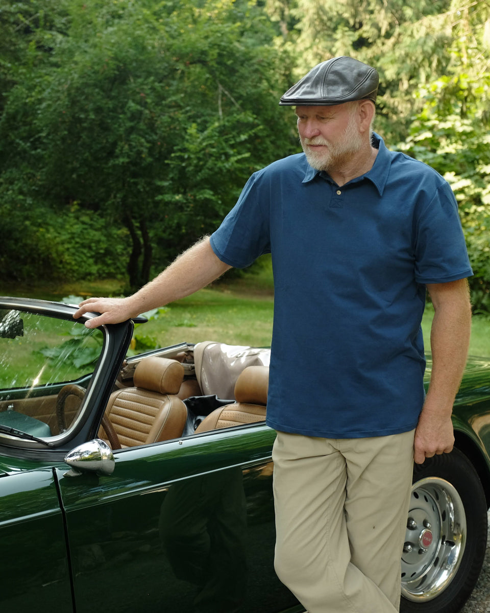 Man wearing the Men's Sombrio Polo sewing pattern from Thread Theory on The Fold Line. A polo shirt pattern made in knit fabric, featuring a relaxed fit, pointed collar, partial button placket, and short sleeves.