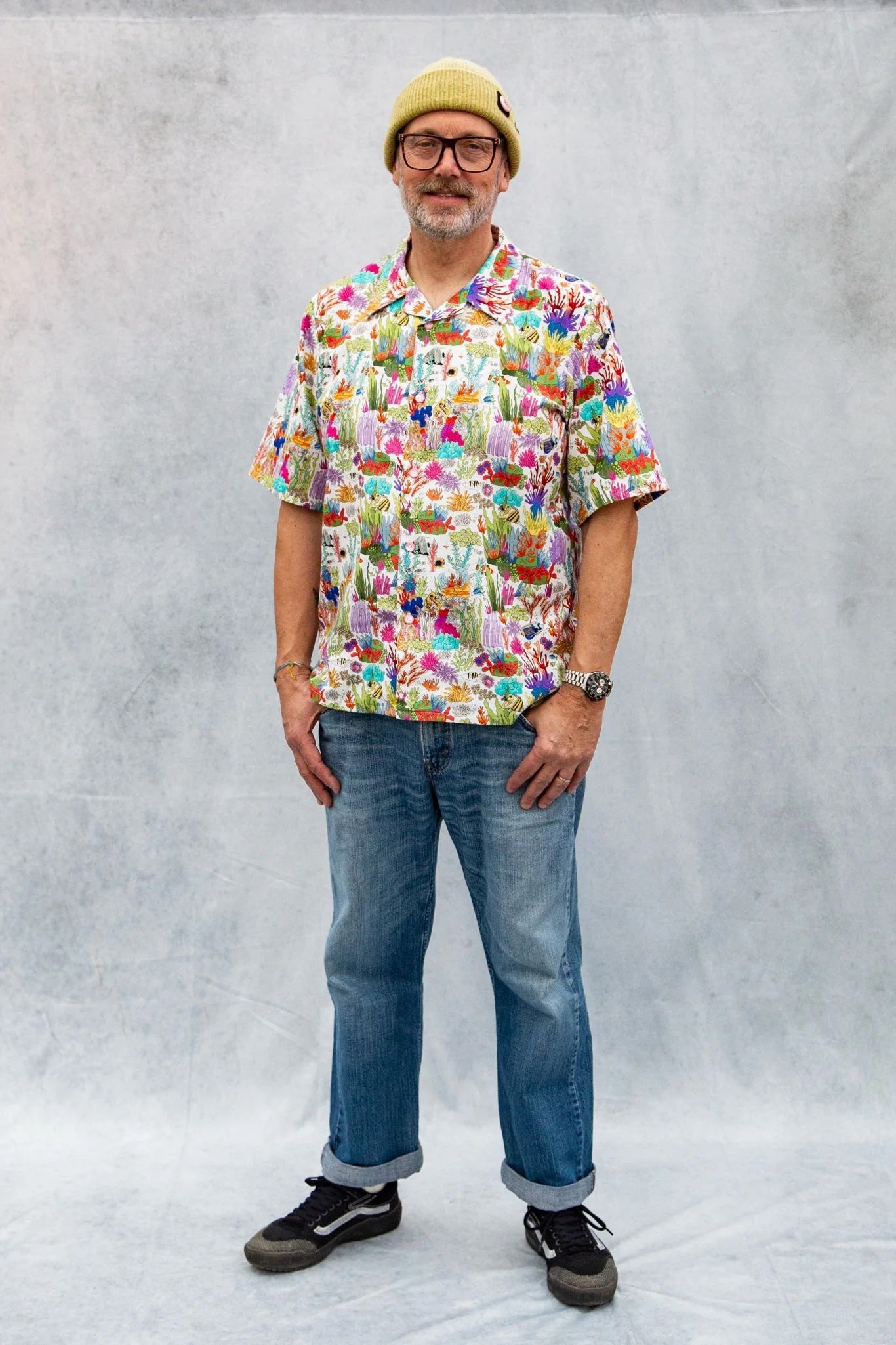 Man wearing the Men's Tony Shirt sewing pattern from Emporia Patterns on The Fold Line. A shirt pattern made in cotton or linen fabric, featuring a loose fit, open collar, button front, and short sleeves.