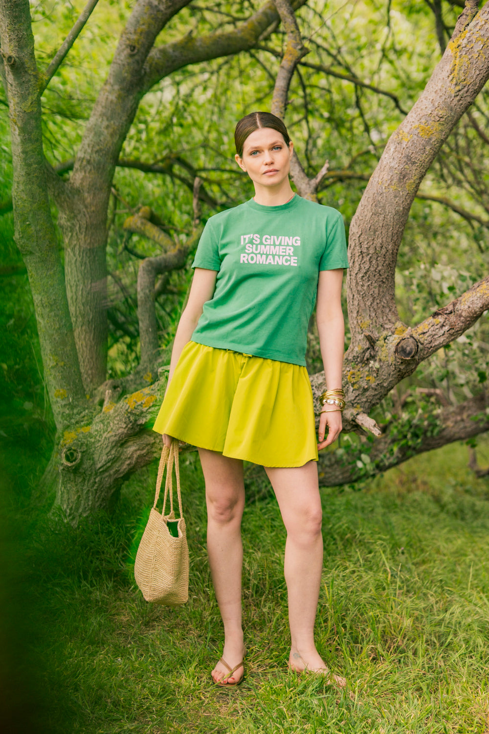 Woman wearing the Mina Shorts sewing pattern from Fibre Mood on The Fold Line. A shorts pattern made in seersucker, poplin, lyocell, linen, satin, broderie anglaise, crinkle jacquard, double gauze, chambray, viscose (crepe), or muslin fabric, featuring an elastic waistband with a tie, side seam pockets, and wide legs.