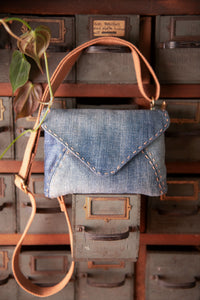 The Missive Bag sewing pattern from Sew Liberated on The Fold Line. A bag pattern made in canvas, oiled canvas, waxed canvas, or twill fabric, featuring an envelope shape, internal zippered pocket, magnetic closure, and detachable strap.