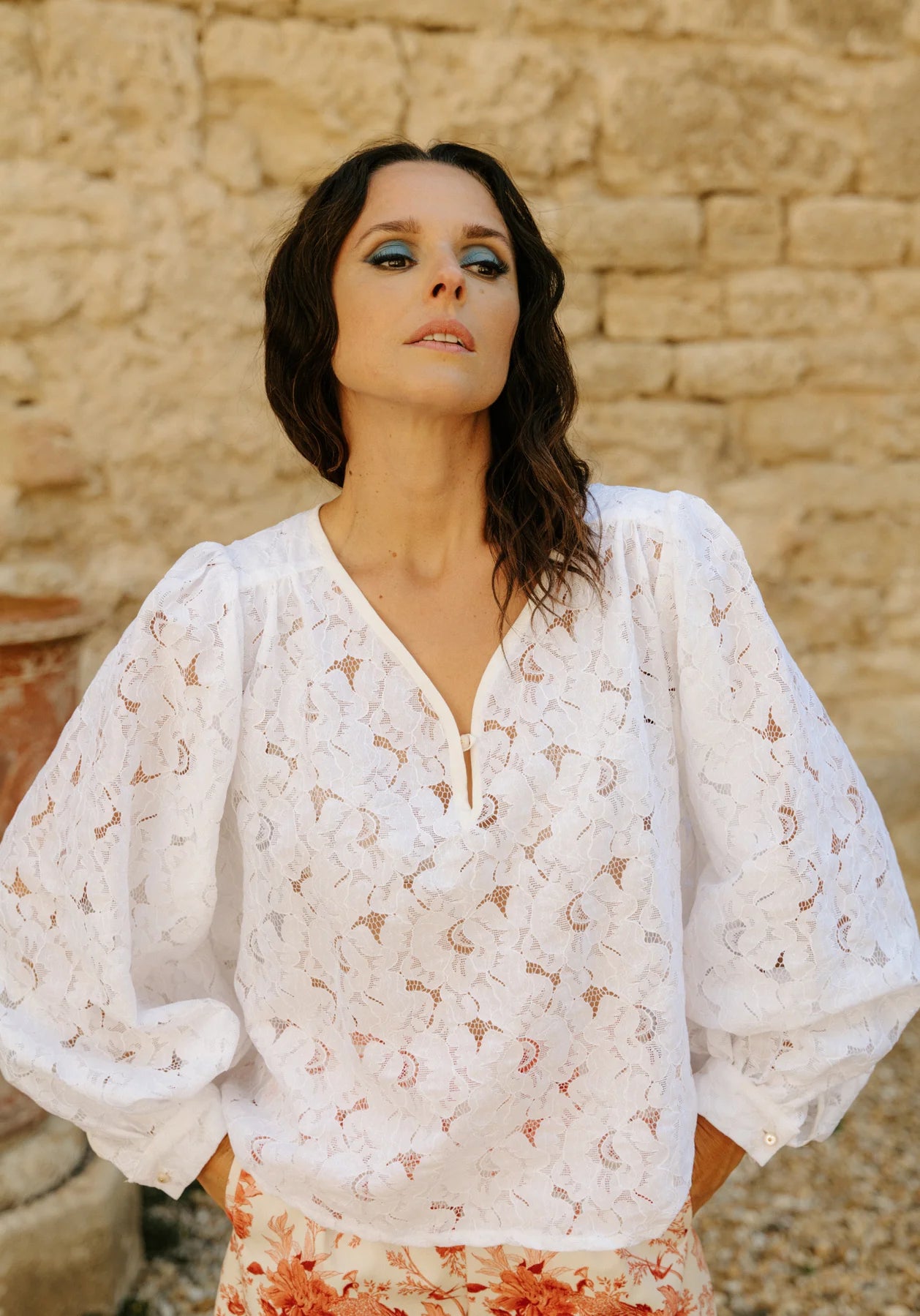 Woman wearing the Missive Blouse sewing pattern from Maison Fauve on The Fold Line. A top pattern made in viscose, soft jacquard, tencel, cotton, crepe, poplin, satin, voile, or twill fabric, featuring a relaxed fit, V-neckline with a button, shoulder yokes, gathering, and voluminous long sleeves with cuffs.