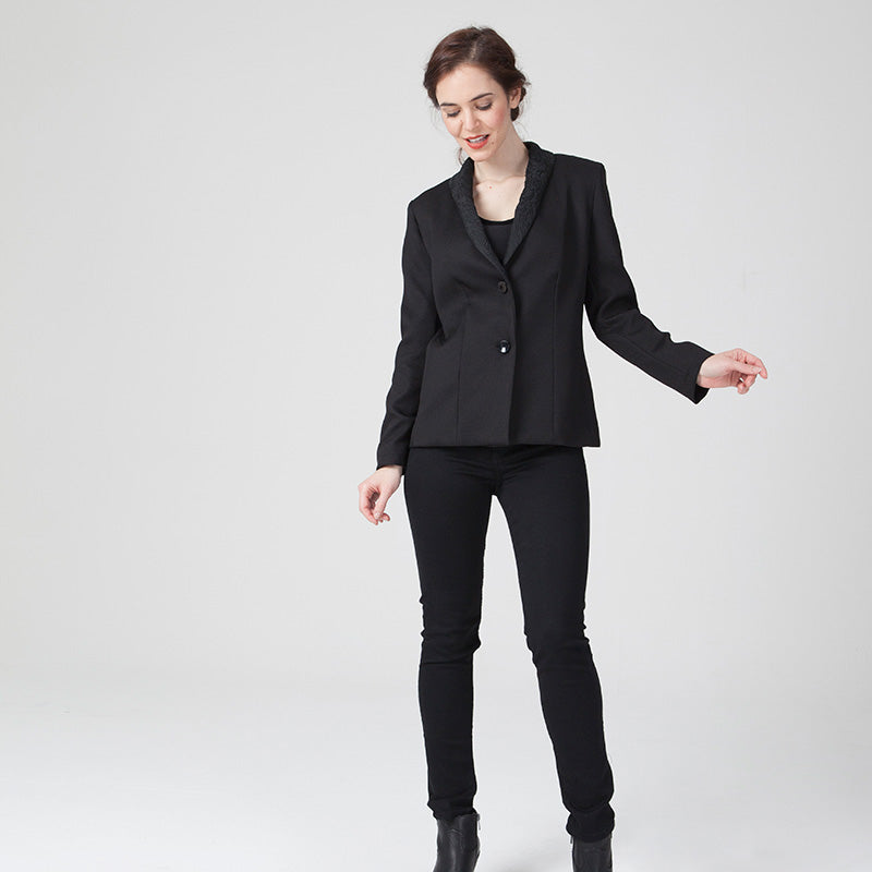 Woman wearing the Nadège Jacket sewing pattern from Coralie Bijasson on The Fold Line. A jacket pattern made in cotton satin, cotton piqué, wool, denim, gabardine, jacquard, or corduroy fabric, featuring a shawl collar, shoulder yoke detail, and button closure.