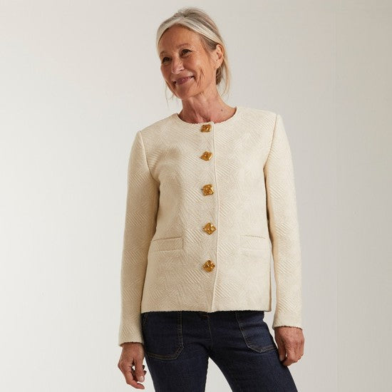 Woman wearing the Nancy Jacket sewing pattern from Coralie Bijasson on The Fold Line. A lined jacket pattern made in tweed, wool, denim, or jacquard fabric, featuring a boxy fit, round neckline, button front, and welt pockets.