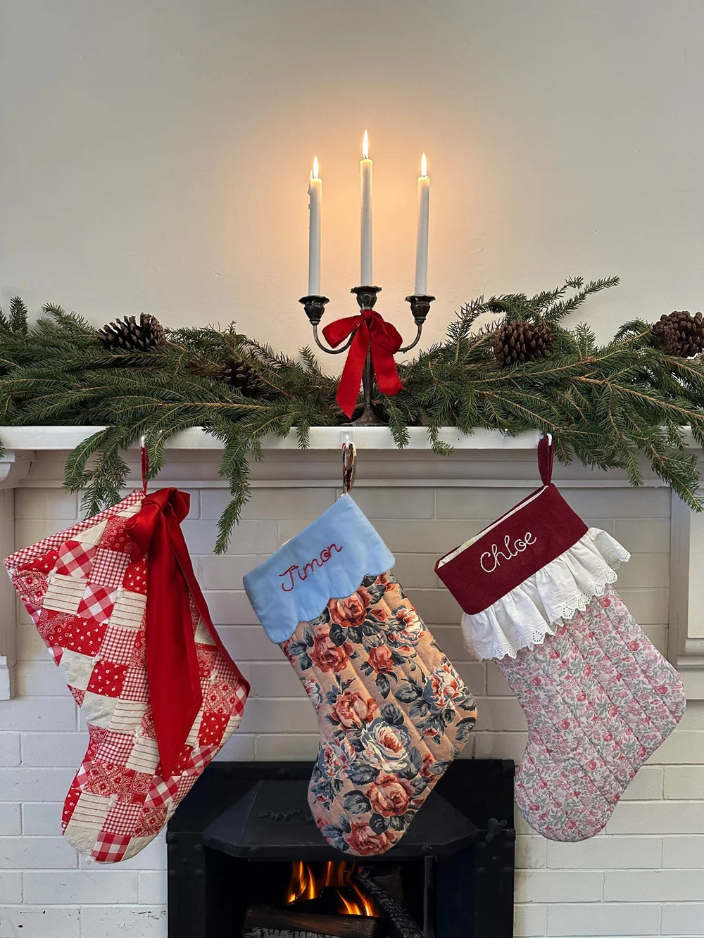 The Nicko Stocking sewing pattern from Victory Patterns on The Fold Line. A Christmas stocking pattern made in cotton or linen fabric, featuring a quilted body and options for a scalloped embroidered cuff, an embroidered cuff with a lace ruffle, or a bow.