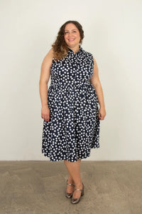 Woman wearing the Nicole Dress Sleeveless Add-on sewing pattern from Sew Over It on The Fold Line. A sleeveless shirt dress pattern made in cotton poplin, cotton lawn, crepe, viscose, or tencel fabric, featuring a collar and collar stand, button front, and below knee length.