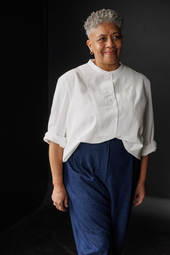 Woman wearing the Niven Shirt sewing pattern from Merchant & Mills on The Fold Line. A shirt pattern made in cotton poplin, cotton chambray, Indian handlooms, hemp/cotton, or lightweight denim fabric, featuring a bib, grandad collar, and long cuffed sleeves.