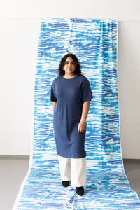 Woman wearing the Nordic Dress sewing pattern from TAUKO on The Fold Line. A dress pattern made in knit or jersey fabric, featuring a relaxed fit, round neckline, and elbow length sleeves.