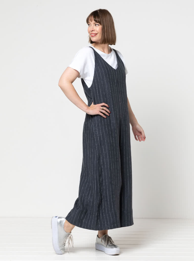 Woman wearing the Norman Jumpsuit sewing pattern from Style Arc on The Fold Line. A pull-on jumpsuit pattern made in washed linen, cotton, or crepe fabric, featuring front and back V-necks, deep armholes, back elastic, in-seam pockets, and wide 7/8 length legs. 