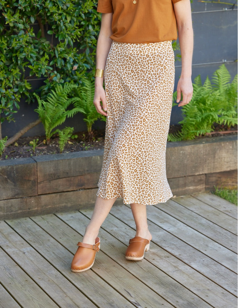 Woman wearing the Nuance Skirt sewing pattern from Atelier Scämmit on The Fold Line. A skirt pattern made in fluid crepe, twill, or satin fabric, featuring a bias cut, invisible zipper, and midi length.
