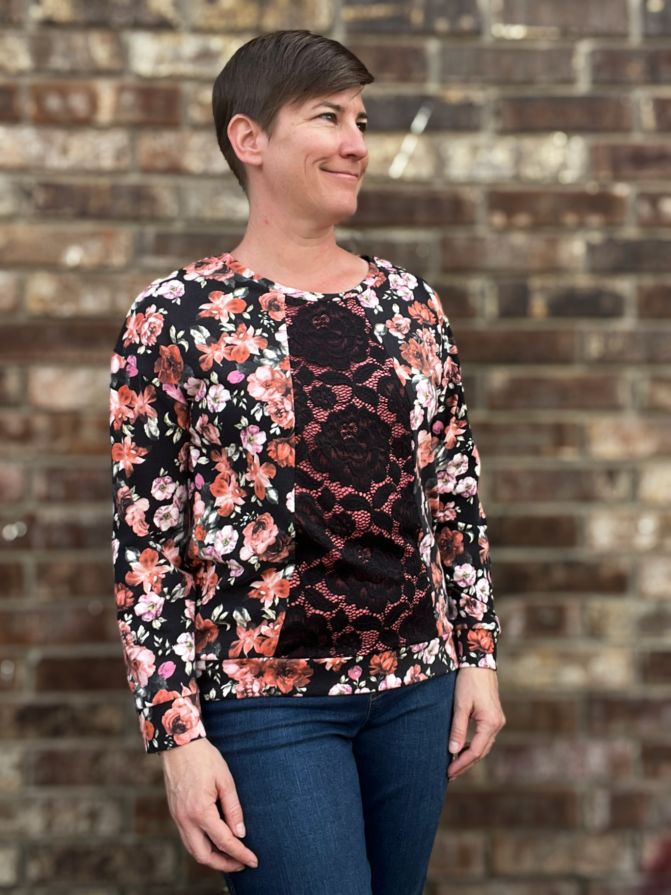 Woman wearing the Nyssa Top sewing pattern from Primrose Dawn on The Fold Line. A top pattern made in jersey, french terry, double brushed poly, sweater knit, hacci, waffle, or pointelle fabric, featuring a round neckline, contrasting centre panel, long drop-shoulder sleeves with cuffs, and a high-low hem with a bottom band.