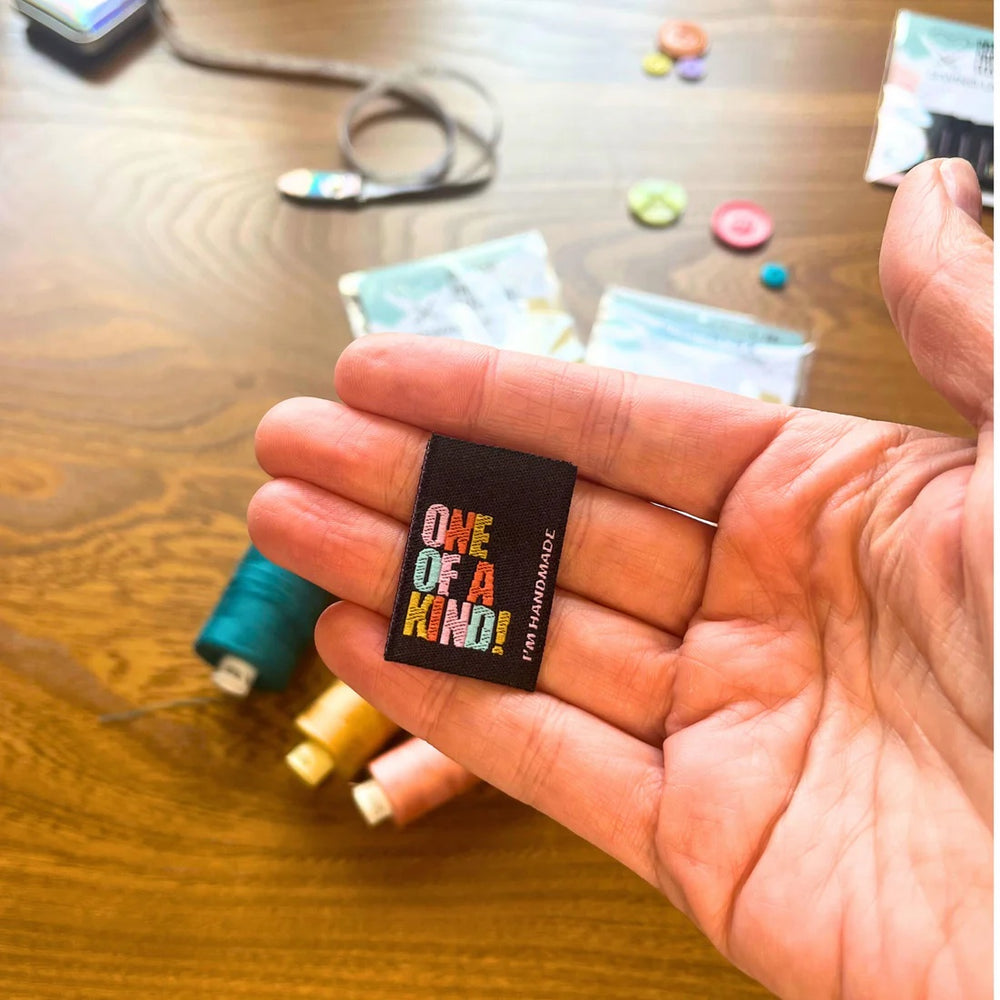 'One of a Kind' woven labels from Pattern Paper Scissors on The Fold Line. The pack includes 6 woven labels ready to be sewn into your handmade clothes.