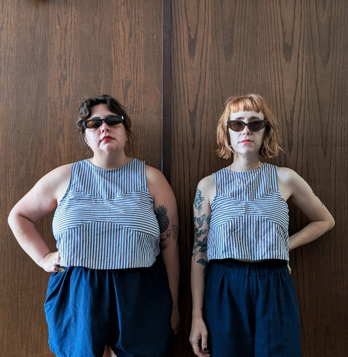 Women wearing the Ornella Top sewing pattern from Spaghetti Western Sewing on The Fold Line. A sleeveless top pattern made in light to mid weight woven fabric, featuring a round neck, scooped armscye, bralette-shaped cutout, and cropped length.