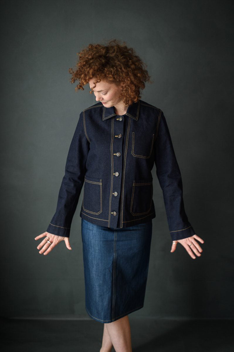 Woman wearing the Ottoline Jacket sewing pattern from Merchant & Mills on The Fold Line. A jacket pattern made in denim, cotton drill, canvas, linen or corduroy fabric featuring a boxy silhouette, front button closure, patch pockets and topstitching.