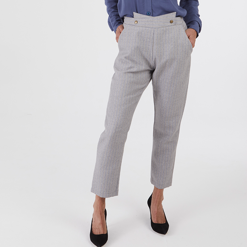 Woman wearing the Palace Pants sewing pattern from Coralie Bijasson on The Fold Line. A pants pattern made in cotton sateen, baby corduroy, denim, or linen fabric, featuring an overlapping front waist detail, elasticated back waist, pockets, and cropped length.