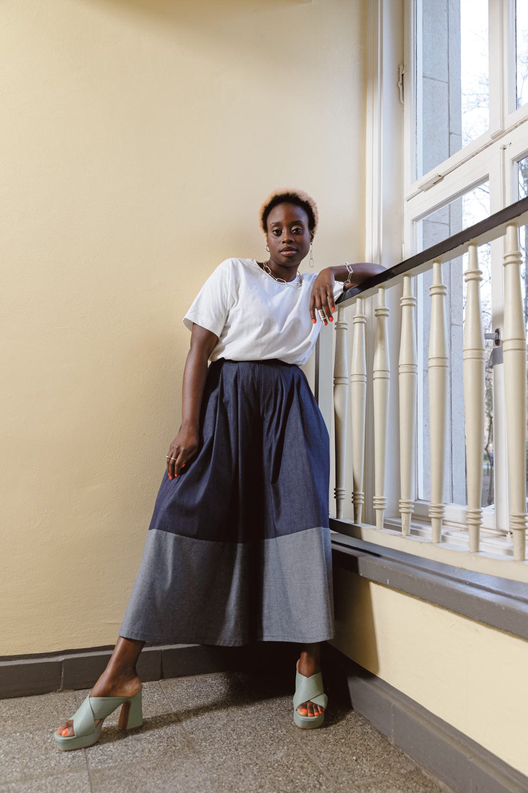 Woman wearing the Panel Trousers sewing pattern from TAUKO on The Fold Line. A trousers pattern made in cotton or linen fabric, featuring a fly front, pockets, and voluminous legs with colour blocked panels.